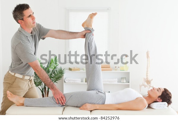 Chiropractor Stretching Females Leg Stock Photo (Edit Now) 84252976