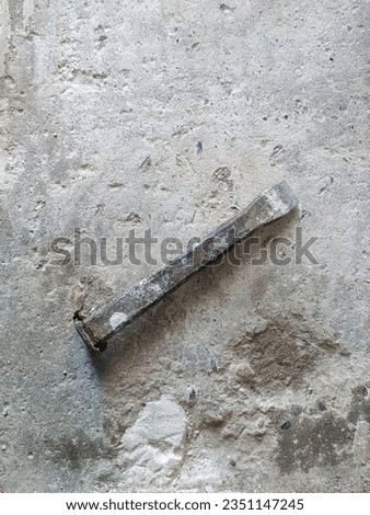 Chisel on concrete slab. Very old construction tool. Renovation of old premises. Preparing for repair work of home. Workplace