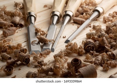 Chisel with wood shavings. Carpenter cabinet maker hand tools on the workbench.