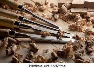 Chisel with wood shavings. Carpenter cabinet maker hand tools on the workbench.