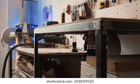 Chisels, screwdrivers, wrench and pliers on wall in furniture assembly shop next to electric router on workbench. Close up of woodworking gear on rack in joinery and power tool - Powered by Shutterstock