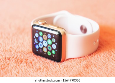 Chisinau, Moldova - August 2019. Apple Watch Series 3 38mm Gold Aluminum Case with Pink Sand Sport Band on a soft fluffy peach-colored background