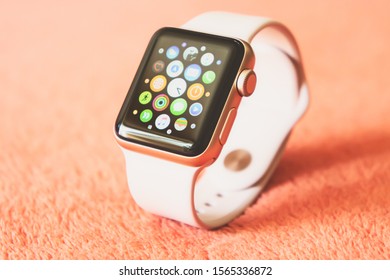 Chisinau, Moldova - August 2019. Apple Watch Series 3 38mm Gold Aluminum Case with Pink Sand Sport Band on a soft fluffy peach-colored background