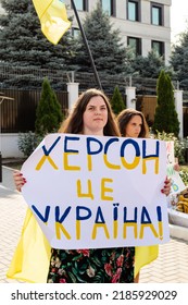 CHISINAU, MOLDOVA - CIRCA JUL 2022: Anti-war protest outside Russian embassy in Chisinau. Woman with poster about Kherson city.