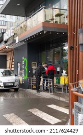 Chisinau, Moldova - January 23, 2022: McDonald's Drive. Cars Line Up On McDonald's Drive. Glovo Delivery Staff Is Waiting For The Order To Be Prepared.