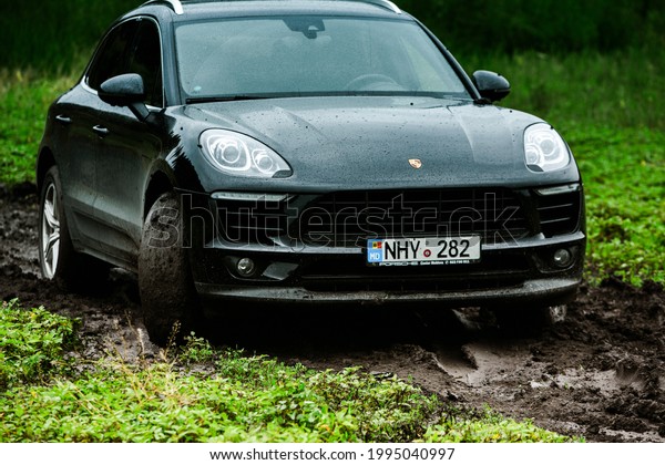 CHISINAU,\
MOLDOVA - JUNE 17, 2021: Porsche Macan S in off-road racing full of\
mood on bad road in Moldova. Editorial\
photo.