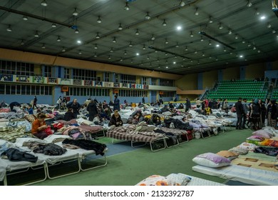 chisinau, moldova - march 4 2022: chisinau arena refugee center with a lot of people and folding beds fow ukrainian refugees