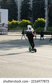 Chisinau, Moldova - October 14, 2022: Young Man Rides On A Paid Mobile Electric Scooter On A Street In Chisinau. An Easy And Flexible Way To Get Around On The Streets