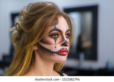 Chisinau,Republic of Moldova- October 31,2018-Salon Victoria Palace: 
Artist applies skull make-up .Halloween skull make up.