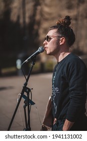 Chiswick, West London | UK -  2021.03.21: Street Musician Singer Singing In Front Of The Small Crowd On Sunny Day