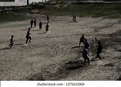 Chitrall, Pakistan - July 28,2018, Local Kids Soccer At Desert Field Over Mountain Backgrund In Nation Of Pakistan