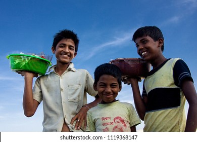 Chittagong, Bangladesh - 06 16 2009: Happy kids at the beach selling nic-nacs 