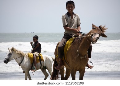 Chittagong, Bangladesh - 06 16 2009: Children riding horses and trying to make a living