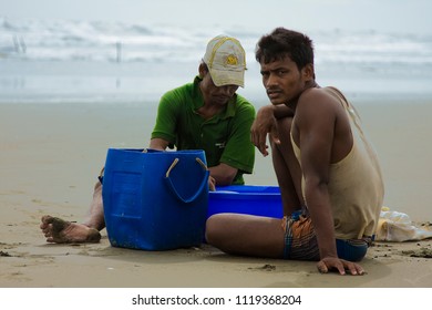 Chittagong, Bangladesh - 06 16 2009: Scavenger men looking for crabs on the beach