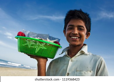 Chittagong, Bangladesh - 06 16 2009: Happy kid at the beach selling nic-nacs 