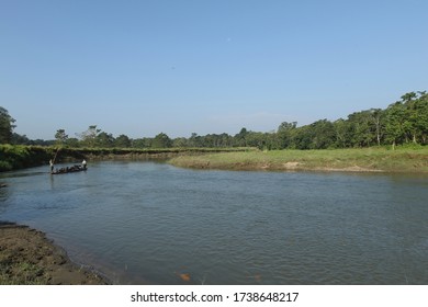 CHITWAN, NEPAL – OCTOBER 20, 2016: Beautiful landscape of Rapti river with wooden boat.