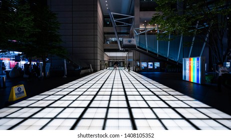 CHIYODA, TOKYO, JAPAN - MAY 23, 2019:  Night View Featuring One Of The Illuminated Entrance Paths From Tokyo International Forum. The Complex Was Designed By Architect Rafael Viñoly.