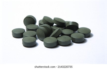 Chlorella Tablets On A White Table Top 