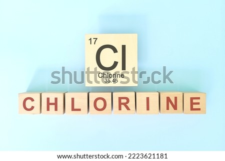 Chlorine chemical element symbol with atomic mass and atomic number in wooden blocks flat lay composition. Chemistry and Science concept.
