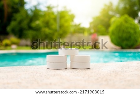 Chlorine tablets for swimming pool cleaning, close up of chlorine tablets on the edge of a swimming pool, chlorine tablets for swimming pool disinfection