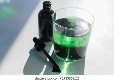 Chlorophyll Drops In Glass Of Water Sitting In Sunlight