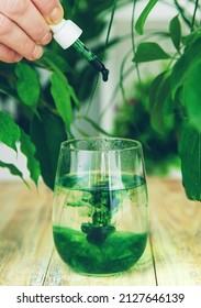 Chlorophyll Supplement In A Glass Of Water. Selective Focus. Nature.