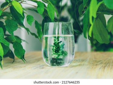 Chlorophyll Supplement In A Glass Of Water. Selective Focus. Nature.