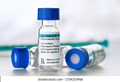 Chloroquine phosphate (generic name, own label design with dummy data - not real product) drug in small injection bottles with blue caps, green syringe background  Potential coronavirus cure concept