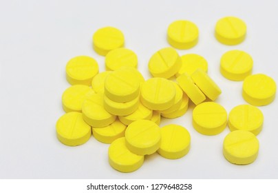 chlorpheniramine yellow pill on white background.