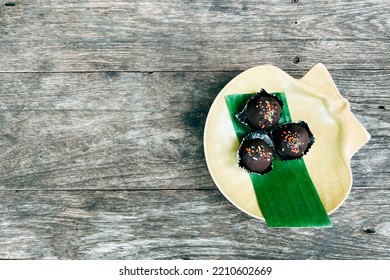 Choc Balls Or Chocolate Balls Topping With Multicolored Rainbow Sprinkles And Colored Sugar Flower In Yellow Ceramic Dish On Wood Table