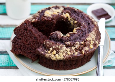 Chocolat bundt cake on a colorful wooden background. 