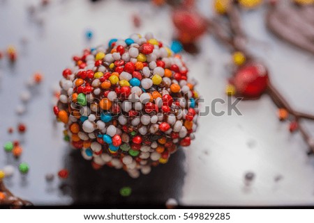 Similar – Dot on chocolate Candy