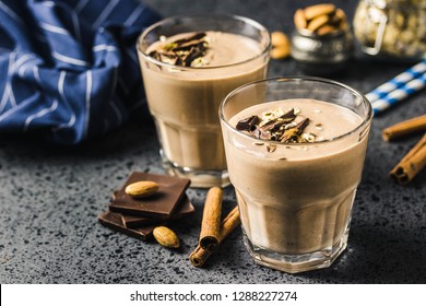 Chocolate almond milk oat smoothie on dark background. Selective focus, space for text.