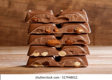 Chocolate with almonds on wooden background