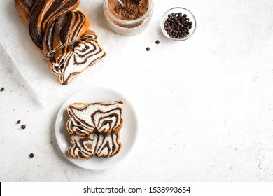 Chocolate Babka Or Brioche Bread. Homemade Sweet Desert Pastry - Chocolate Swirl Bread, Sliced On White Background, Top View, Copy Space.