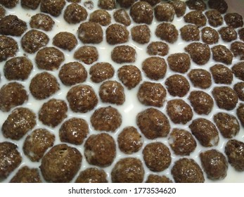 Chocolate ball or chocoball in fresh milk. Morning routine. Breakfast for student and worker. Easy to prepare. Milk with cereal.