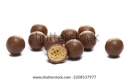 Chocolate balls half with crunchy sweet isolated on white  