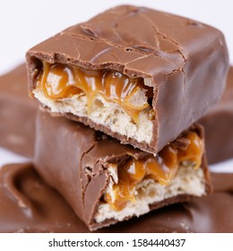 Chocolate Bar With Caramel Fillings. Sweet Chocolate Bar Broken Into Two Pieces.