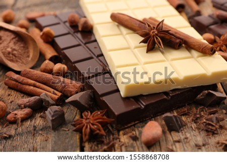 Similar – Image, Stock Photo Chocolate bar on cocoa powder pile. Chocolate and ingredients