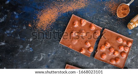 Similar – Image, Stock Photo Chocolate bar on cocoa powder pile. Chocolate and ingredients