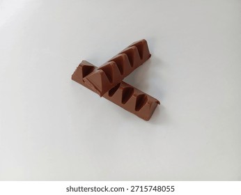 chocolate bar in triangular prism shape on white background
