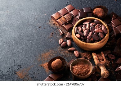 Chocolate bean cocoa. Composition of cocoa powder, bean cocoa bars and pieces of different milk and dark chocolate on black background. Baking Chocolate Texture. Top view with copy space. Mock up.
