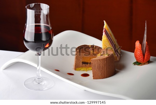 Chocolate and\
berries cake with glass of dessert\
wine