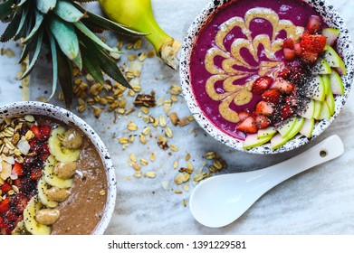 Chocolate And Berry Smoothie Bowls Made From Oats And Acai In A Bowl Decorated With Fresh Fruits (strawberries, Apple, Banana And Almonds) Served On A Marble Board