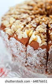 Chocolate birthday cake with almonds and coconuts