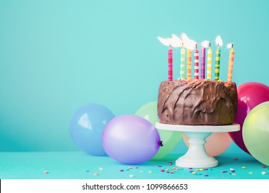 Chocolate Birthday Cake With Colorful Candles And Balloons