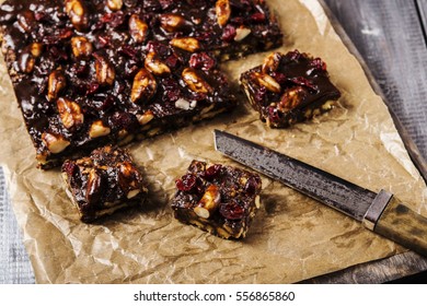 Chocolate And Biscuit Cake With Brazil Nuts And Dried Cranberries Sliced Into Pieces. Selective Focus 