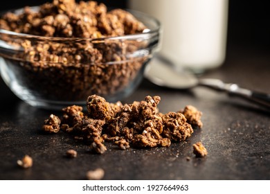 Chocolate breakfast cereal. Morning granola on black table.