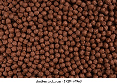 Chocolate breakfast cereal texture. Cereal balls as background. Chocolate corn balls. Top view.