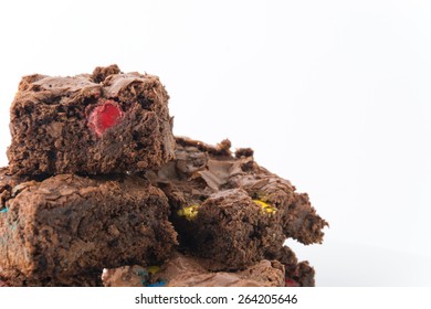 chocolate brownie with chocolate chips on white background